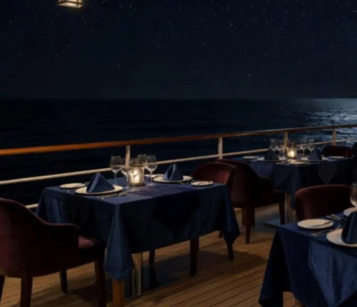 Night-time ocean terrace dining on a cruise ship under the stars